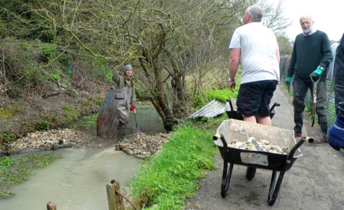 Photos shows volunteers installing flow deflectors